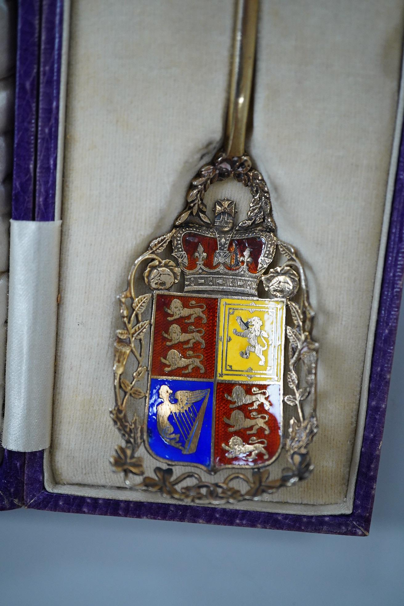 A cased silver gilt and polychrome enamelled spoon, the terminal modelled as the crest of the Worshipful Company of Joiners and Ceilers, to commemorate the Coronation of George V in 1911, Levi & Salaman, London, 1910, 17